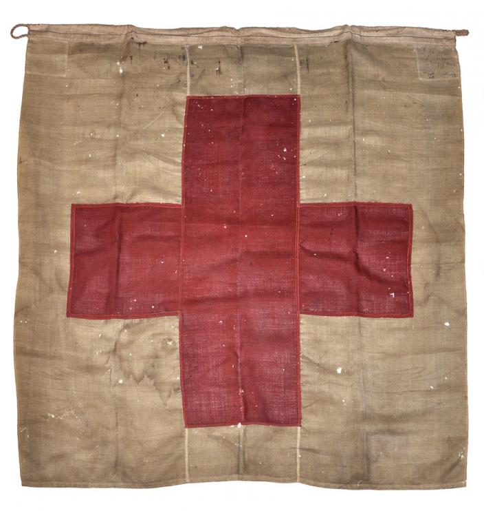 "100 year old flag with red cross symbol."